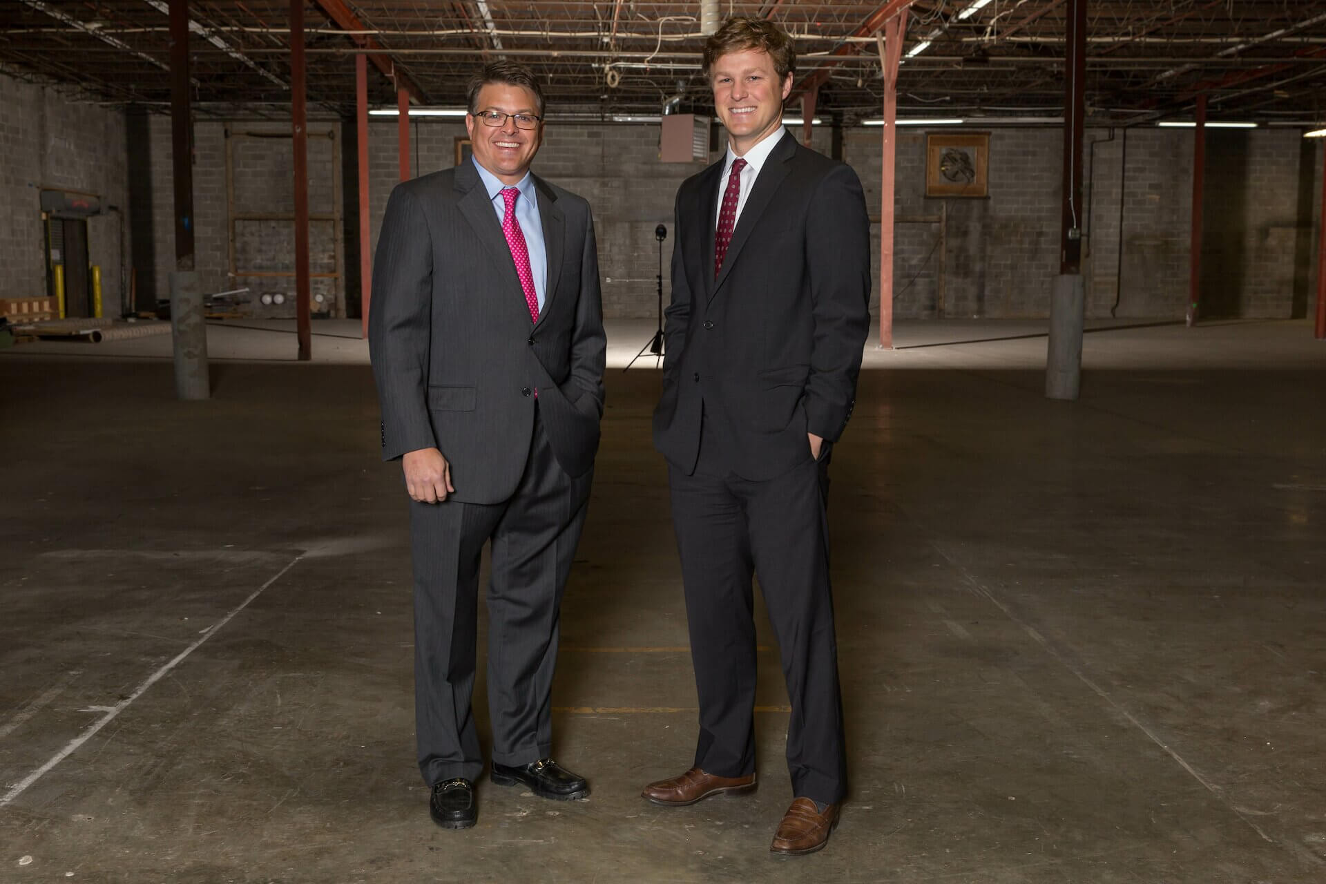 Two Wilson Hull & Neal employees standing in a commercial building