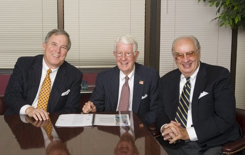 Wilson Hull & Neal's founding partners sitting at a table.